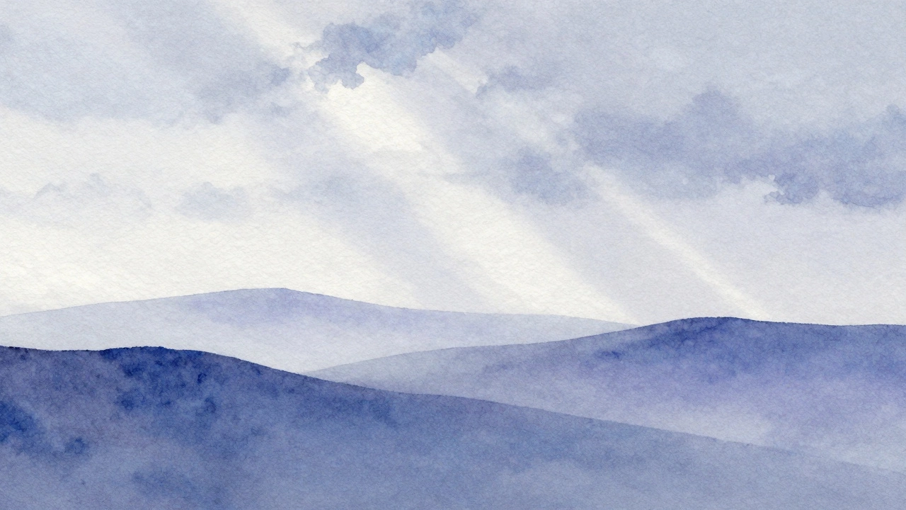 Misty blue mountains fading into distance with soft edges.